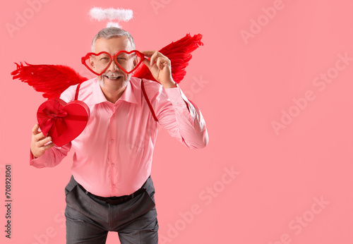 Mature man dressed as Cupid...