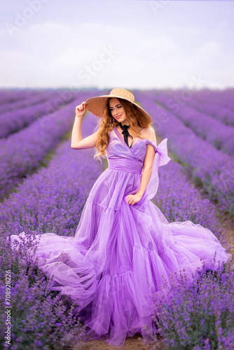 beautiful woman in a lush lilac dress in a field of lavender