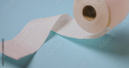 toilet paper roll bouncing on blue background photo