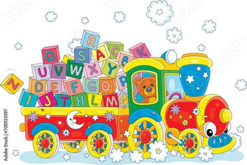 Teddy bear in a funny toy train and trail full of colorful baby cubes with letters of English alphabet, vector cartoon illustration on a white background