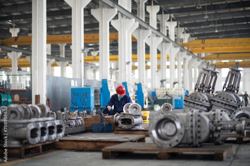 Fototapeta premium Warehouse of products from large water pipes and gas taps at a metal structures factory