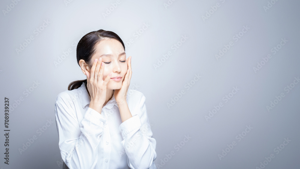 Young beautiful Asian woman with healthy fresh skin wearing white clothes on neutral background, skin care, cosmetology, beauty and spa, Asian woman portrait Young beautiful Asian woman with healthy fresh skin wearing white clothes on neutral background, skin care, cosmetology, beauty and spa, Asian woman portrait