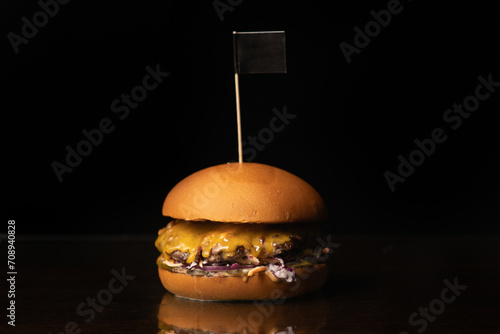 Burger with cheese and flagon. Black background
