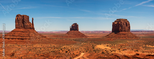 Monument valley landscape, Utah, USA. The west and east Mitten, Merrick Butte . clear blue sky, dirt road passing infront, desert landscape