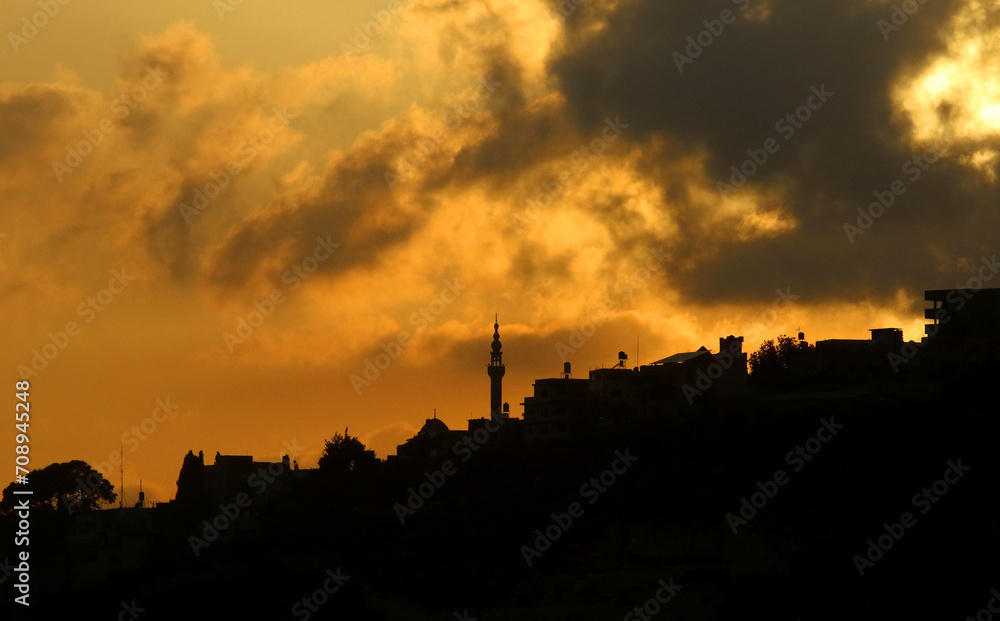 Sunset, mountains and mosque minaret