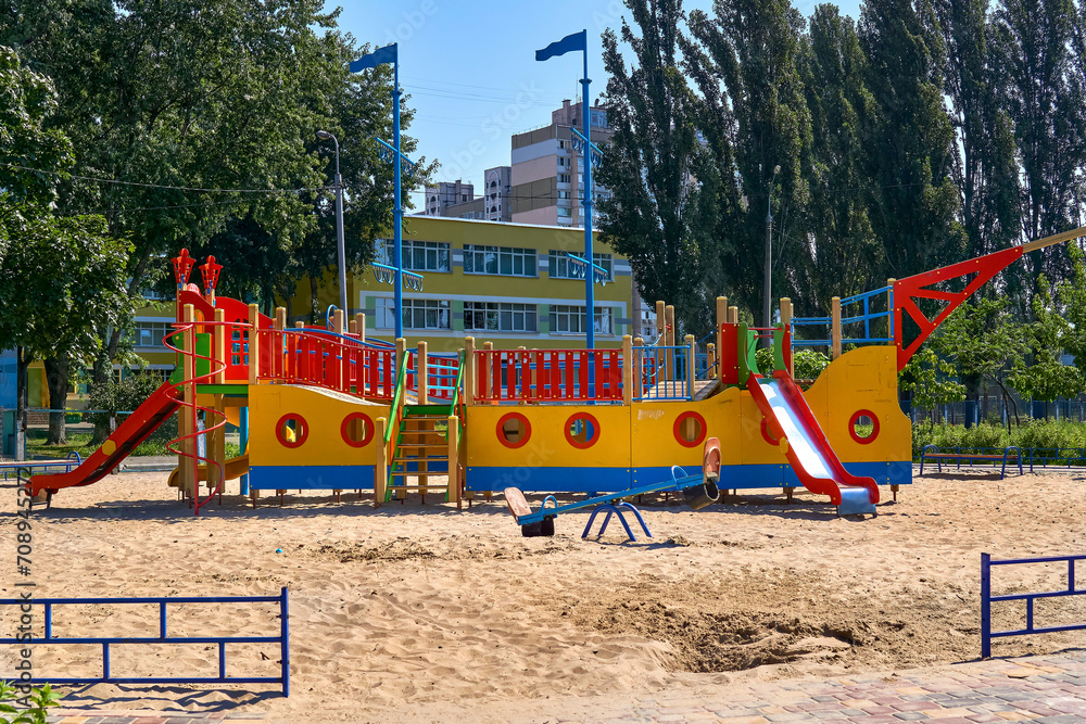 Summer spring children's playground with painted toy ship in park Summer spring children's playground with painted toy ship in park