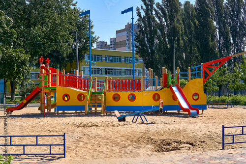 Summer spring children's playground with painted toy ship in park