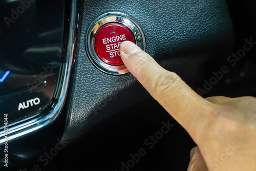 Quadro su tela finger pressing the Engine start stop button of a car