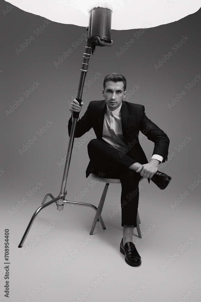 Fototapeta premium elegant model man in black suit in photostudio. black and white