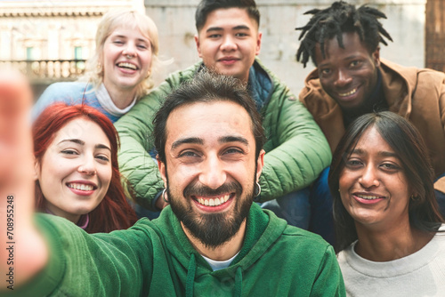 Group of diverse friends sharing a joyful moment in a selfie.