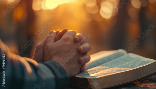 hands pray to God with the bible photo