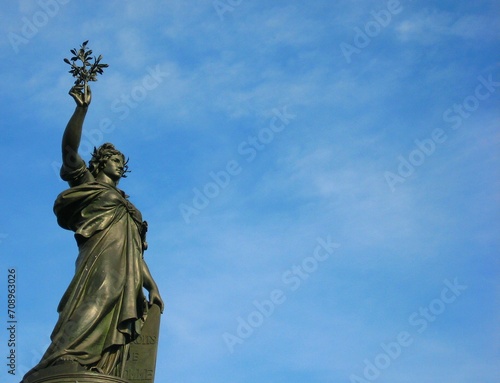 Marianne Statue at Place de la Republique under blue sky in Paris, France photo