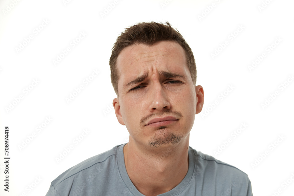 Portrait of offended frustrated young man on white background. sadness Portrait of offended frustrated young man on white background. sadness