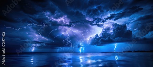 Intense lightning at night, above water. photo