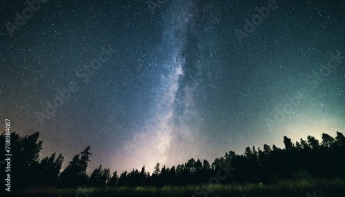 abstract time lapse night sky with shooting stars over forest landscape milky way glowing lights background