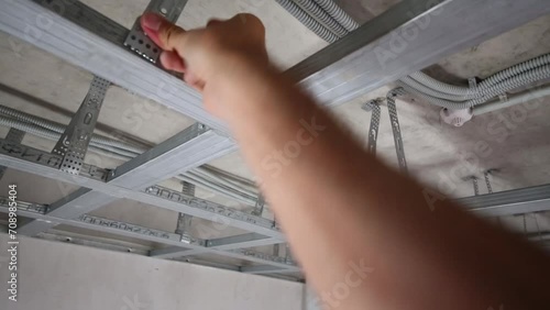 framework for hung ceiling and hand correcting frame photo