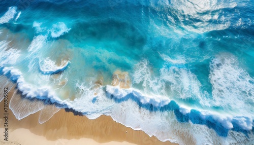summer seascape beautiful waves blue sea water in sunny day top view from drone sea aerial view amazing tropical nature background beautiful bright sea with waves splashing and beach sand concept