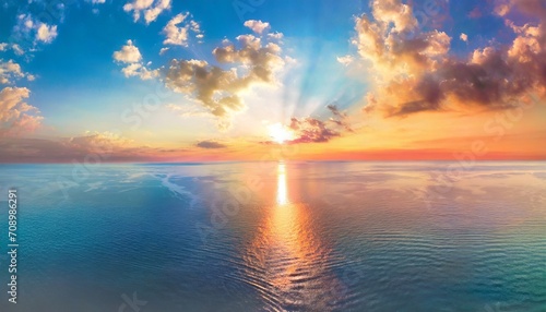 aerial panoramic view of sunset over ocean colorful sky clouds water beautiful serene scene wide angle seascape drone view majestic stunning nature background best sea sky sunrise inspire views © Richard