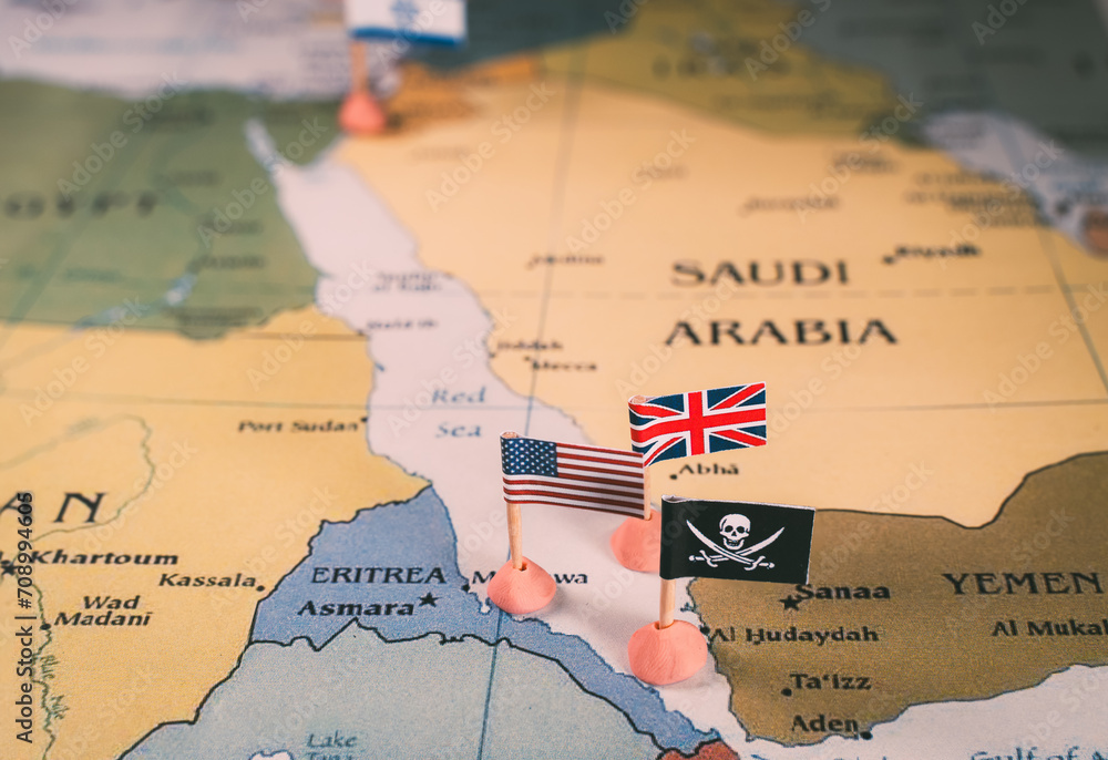 Flags of the United States and United Kingdom surrounding a pirate insignia onto a map of the Red Sea region. vertical video. It symbolically represents the intricate geopolitical dynamics and