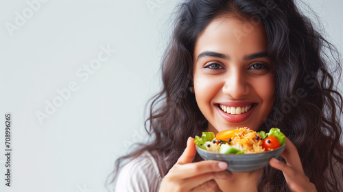Healthy Meal. Portrait Of Happy Casual Indian Woman Eating Tasty Fresh Vegetable Salad, Isolated On Blue Background