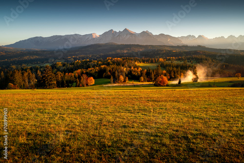 Fototapeta Naklejka Na Ścianę i Meble -  View on Tatra peaks from Łapszanka. Podhale, Poland. Golden hour in the countryside.
