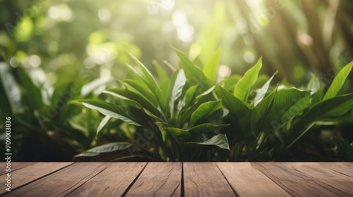 An inviting wooden table foreground with a vibrant backdrop of lush green foliage bathed in natural sunlight.