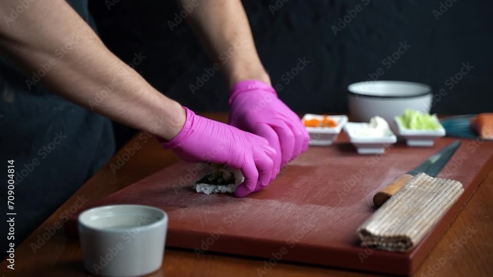 A chef prepares sushi in a restaurant A chef prepares sushi in a restaurant
