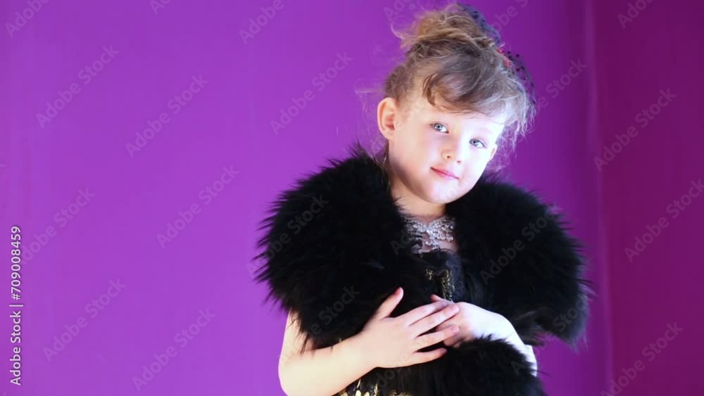 Little girl with stole on her shoulders spins in front of mirror. Little girl with stole on her shoulders spins in front of mirror.