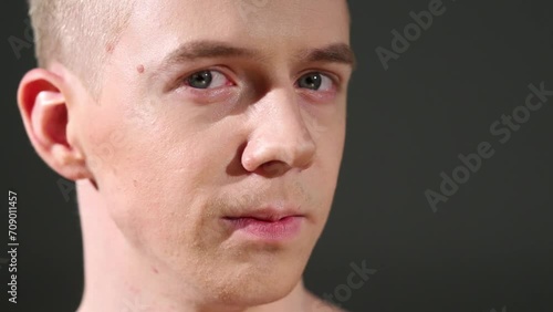 Close up portrait of handsome head-turning man on grey background photo