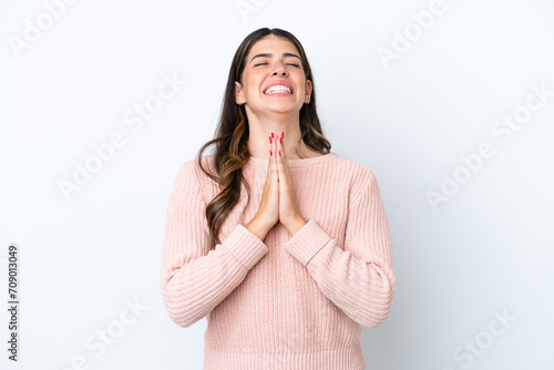 Young Italian woman isolated on white background keeps palm together. Person asks for something