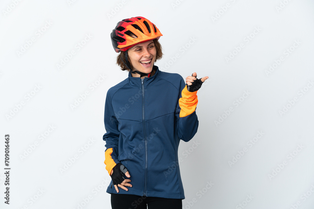 Young English cyclist woman isolated on white background pointing finger to the side and presenting a product Young English cyclist woman isolated on white background pointing finger to the side and presenting a product