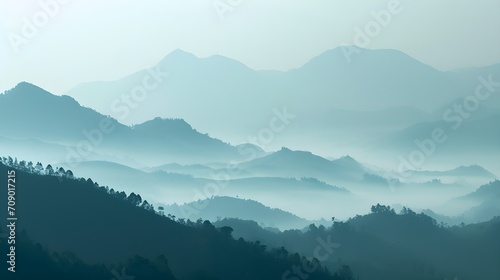 tranquil morning with layers of mountains veiled in mist, showcasing the serene beauty of untouched nature. © PSCL RDL