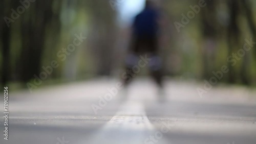 Wallpaper Mural Boy riding on roller skates in summer park at day.  Torontodigital.ca