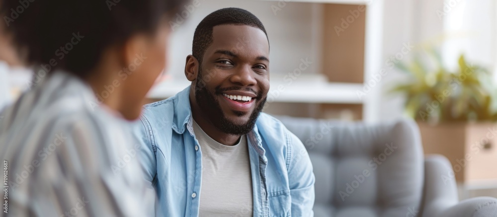 Positive therapy session. Happy African American man discussing progress with psychologist at office. Positive therapy session. Happy African American man discussing progress with psychologist at office.