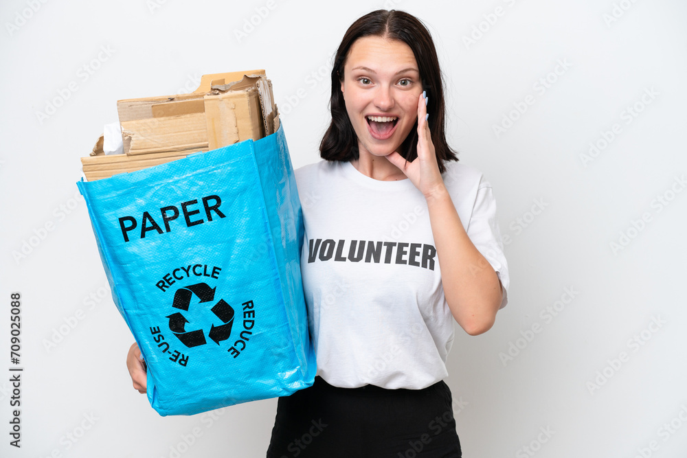 Young caucasian woman holding a recycling bag full of paper to recycle isolated on white background with surprise and shocked facial expression Young caucasian woman holding a recycling bag full of paper to recycle isolated on white background with surprise and shocked facial expression