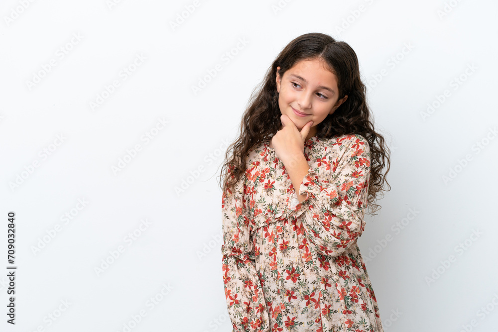 Little caucasian girl isolated on white background looking to the side and smiling Little caucasian girl isolated on white background looking to the side and smiling