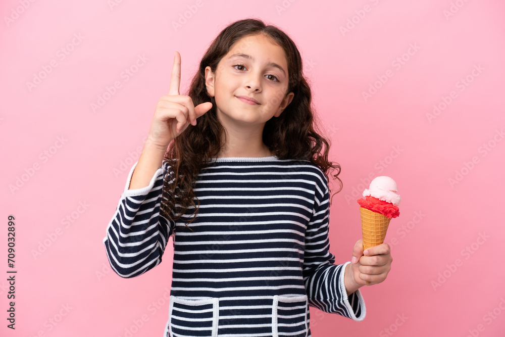 Little caucasian girl holding an ice cream isolated on pink background pointing up a great idea Little caucasian girl holding an ice cream isolated on pink background pointing up a great idea