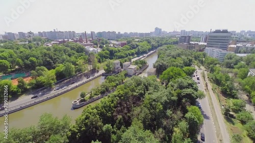 Cars drive by embankment of Jauza river with two sluices  photo