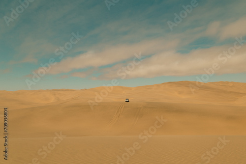 Car driving the sand dunes in Sandwich Harbour Historic, Namibia
