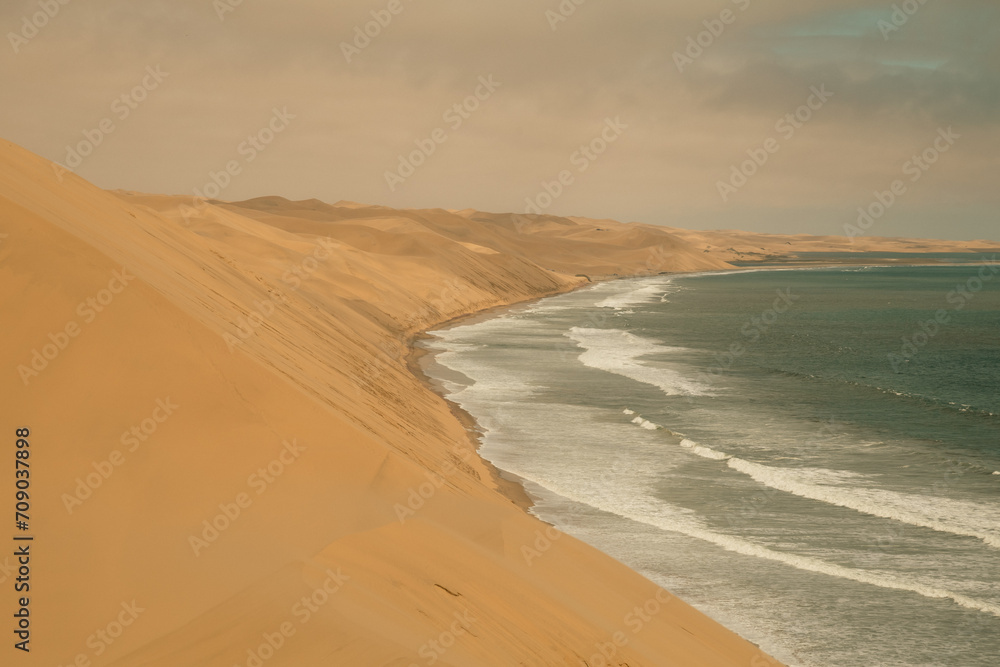 Ocean meets the Sand dunes in Sandwich Harbour Historic, Namibia Ocean meets the Sand dunes in Sandwich Harbour Historic, Namibia