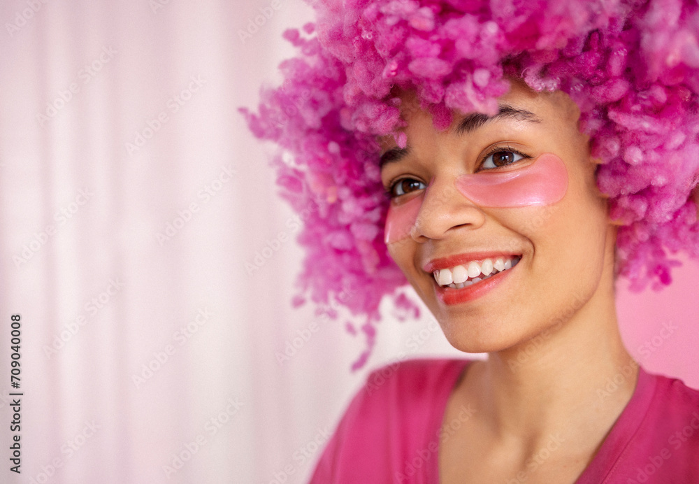 Close up of portrait of attractive happy darkskinned girl with soft pink curly wig. Close up of portrait of attractive happy darkskinned girl with soft pink curly wig.