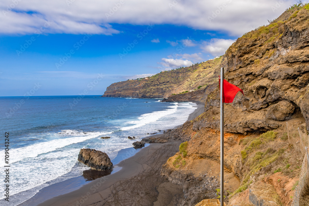 Warning red flag on the beach in Tenerife dangerous Atlantic Ocean