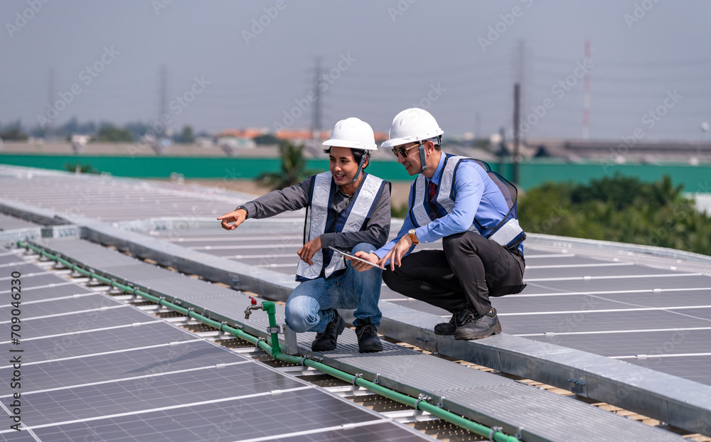 Engineers walking on roof inspect and check solar cell panel by hold equipment box and radio communication ,solar cell is smart grid ecology energy sunlight alternative power factory concept Engineers walking on roof inspect and check solar cell panel by hold equipment box and radio communication ,solar cell is smart grid ecology energy sunlight alternative power factory concept