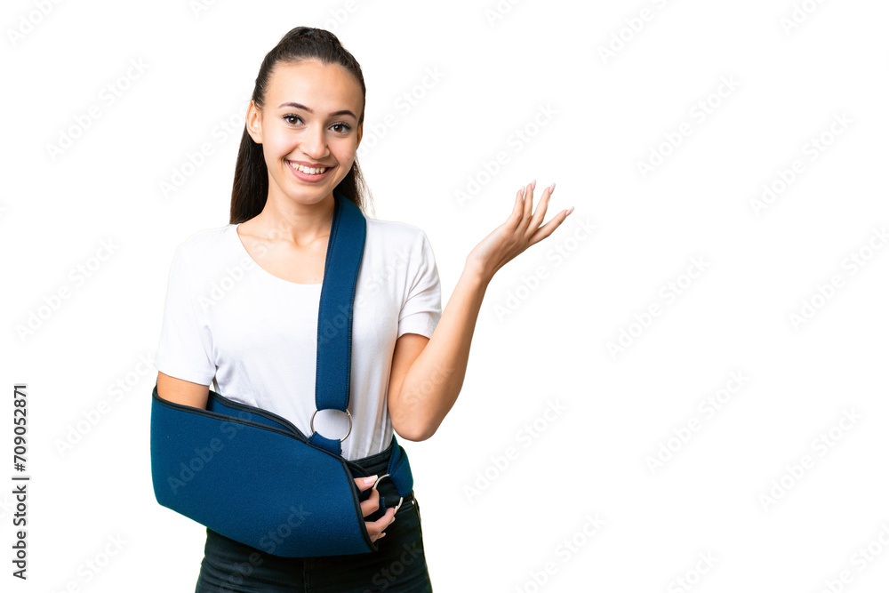Young Arabian woman with broken arm and wearing a sling over isolated chroma key background extending hands to the side for inviting to come Young Arabian woman with broken arm and wearing a sling over isolated chroma key background extending hands to the side for inviting to come