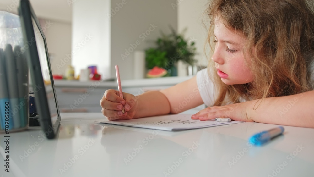 Cute Caucasian Girl Primary School Student Doing Homework using Tablet Cute Caucasian Girl Primary School Student Doing Homework using Tablet