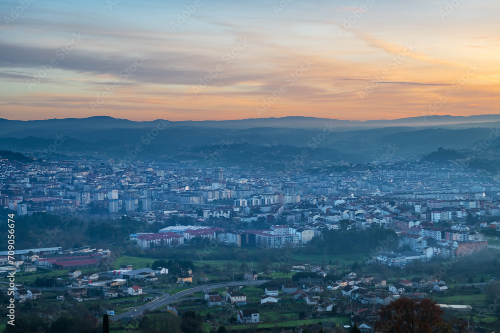 Panorama view of the skyline of the Galician city of Ourense at dusk as seen from the outskirts.