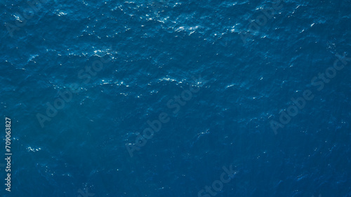 Aerial View Of Surface Of deep dark blue Sea with reflection of the sun's rays as background for page, template or web banner photo
