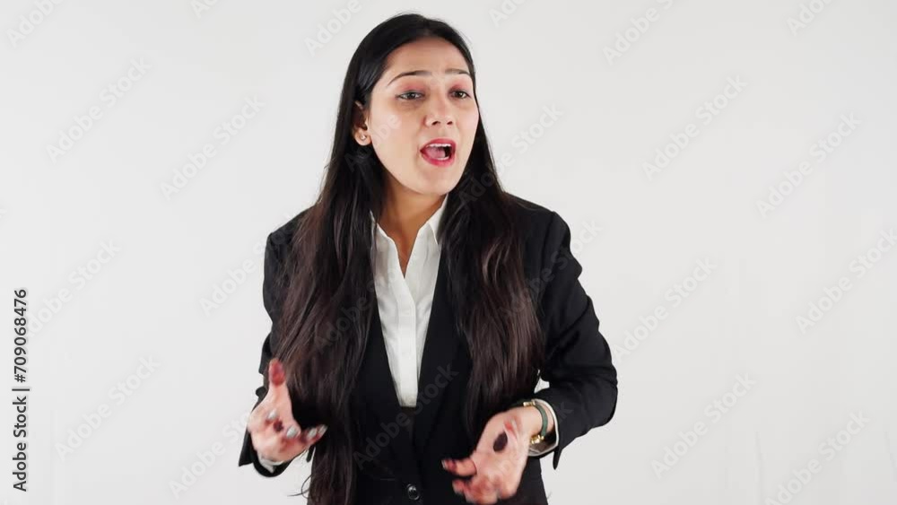 Professional woman in business attire gesturing during a presentation against a white background Professional woman in business attire gesturing during a presentation against a white background