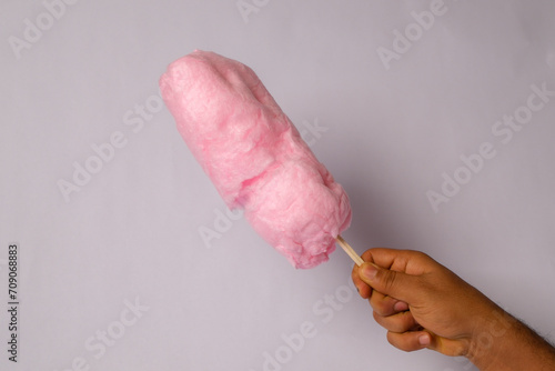 phooto of pink cotton candy on a wooden stick photo