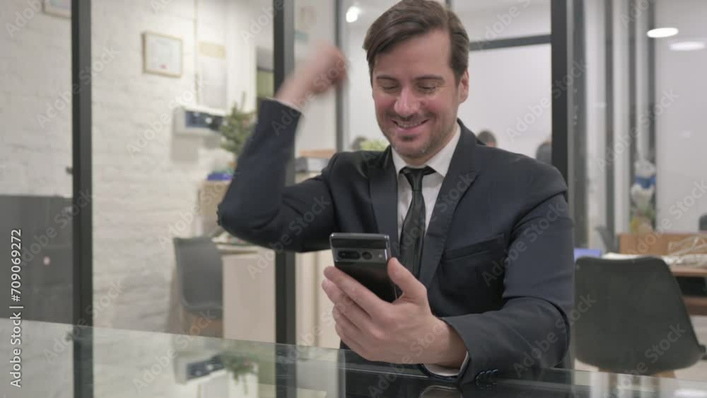 Excited Middle Aged Businessman Earning Money Online on Phone Excited Middle Aged Businessman Earning Money Online on Phone